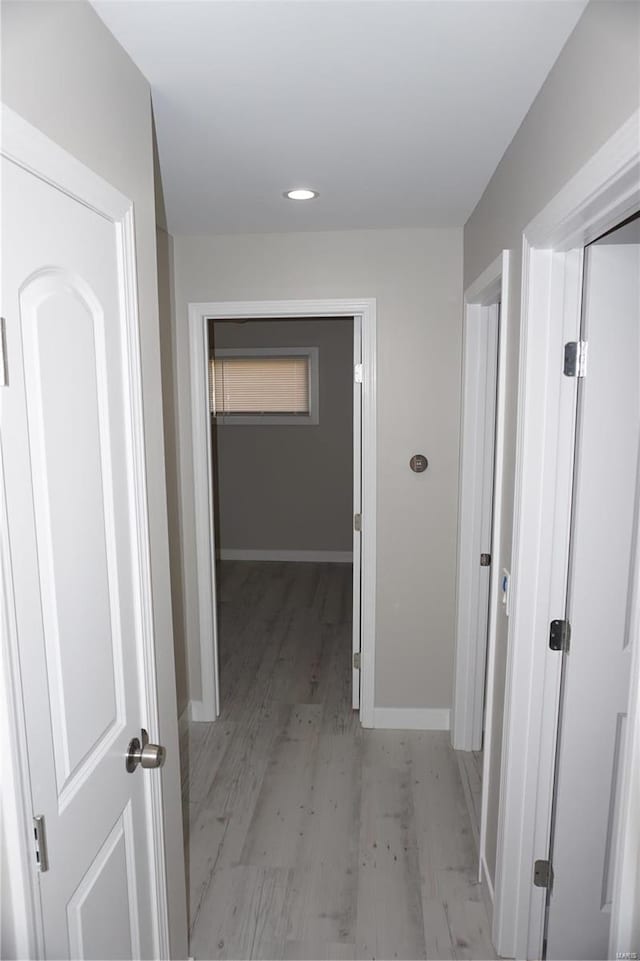 corridor with light hardwood / wood-style flooring