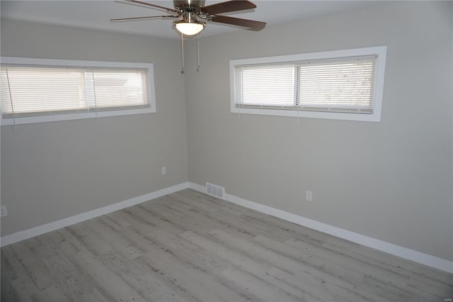 unfurnished room with ceiling fan and light wood-type flooring