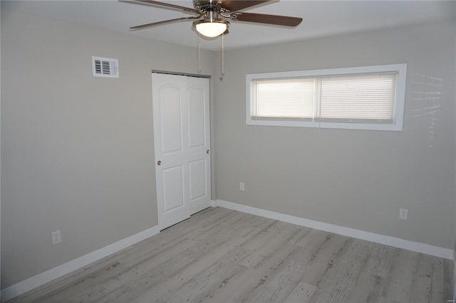 empty room featuring ceiling fan and light hardwood / wood-style floors