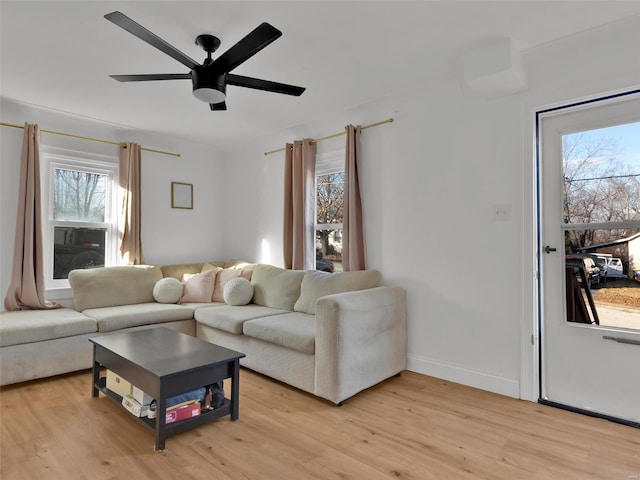 living room featuring light wood-type flooring and ceiling fan