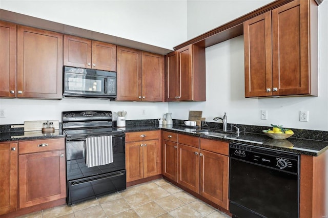 kitchen featuring light tile patterned flooring, sink, dark stone countertops, and black appliances