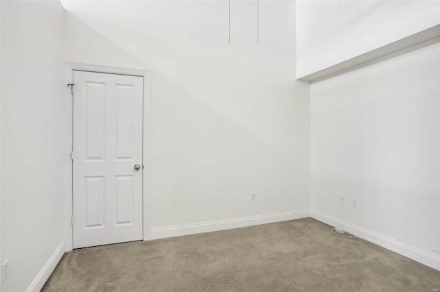 carpeted empty room featuring vaulted ceiling