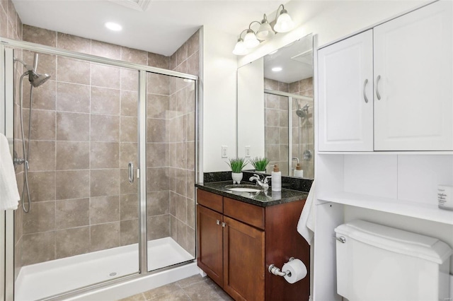 bathroom featuring vanity, toilet, and walk in shower