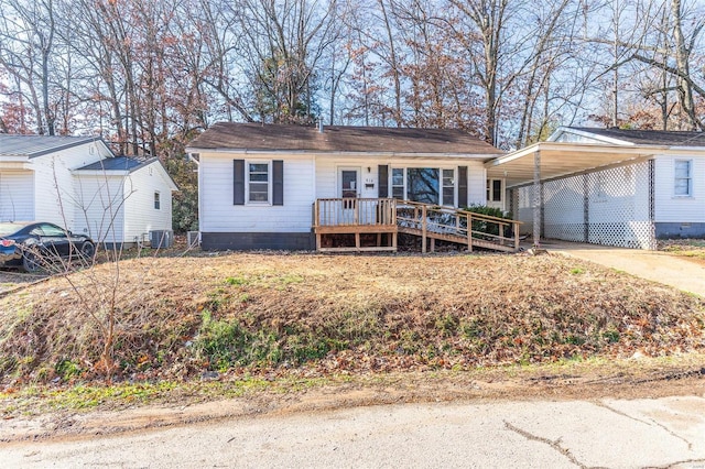 view of front of home with a carport and cooling unit