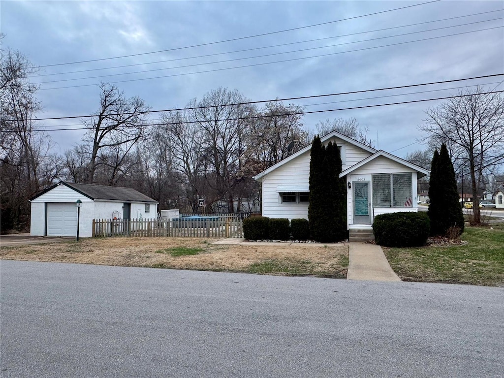 view of property exterior featuring a garage and an outdoor structure