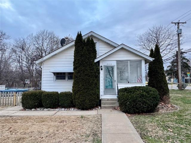 bungalow-style house featuring a front yard