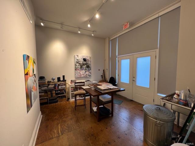 office with dark hardwood / wood-style flooring and french doors