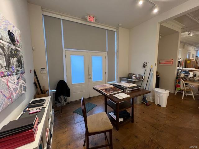 office area with dark hardwood / wood-style floors, rail lighting, and french doors