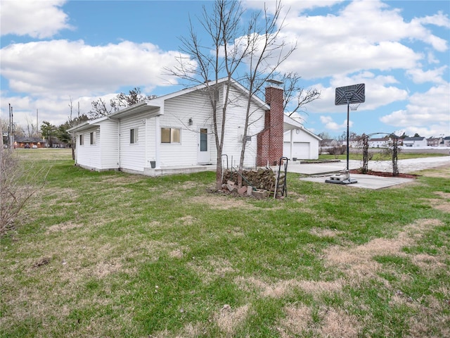 view of property exterior with a garage and a lawn