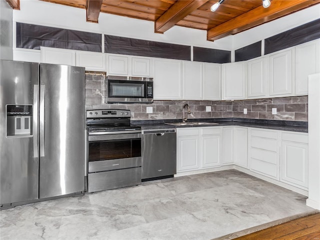 kitchen with appliances with stainless steel finishes, wood ceiling, sink, beam ceiling, and white cabinetry