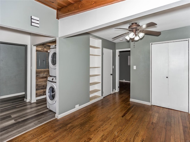 washroom with dark hardwood / wood-style flooring, stacked washer and dryer, and ceiling fan