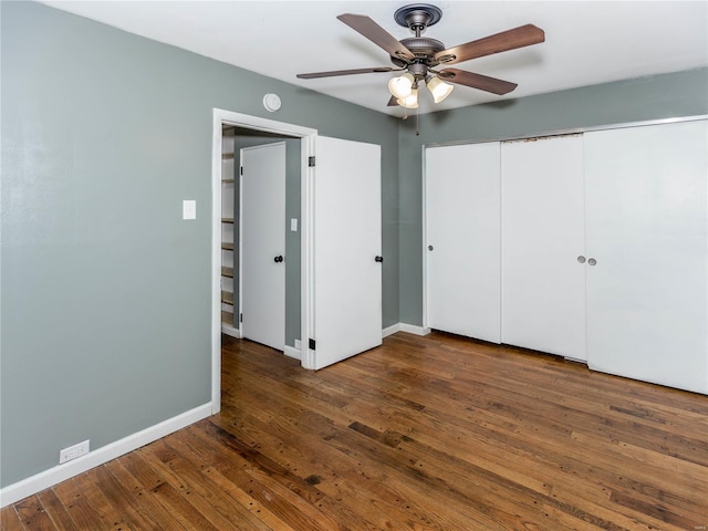 unfurnished bedroom with dark hardwood / wood-style floors and ceiling fan