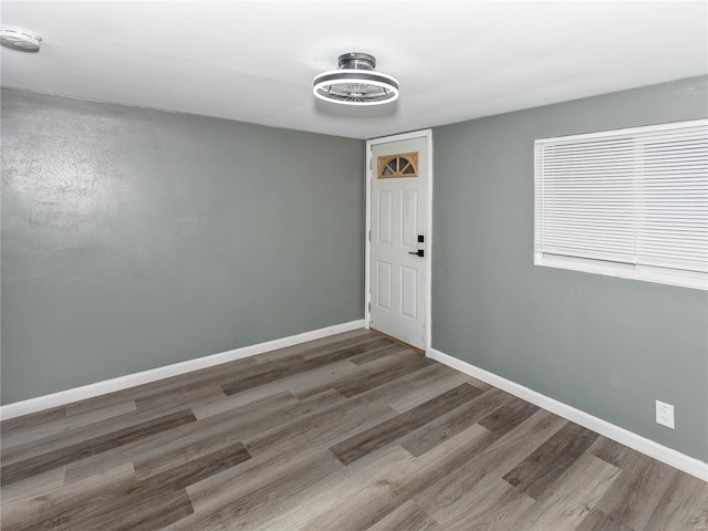 empty room with dark hardwood / wood-style flooring