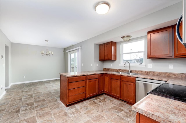 kitchen with kitchen peninsula, sink, dishwasher, a chandelier, and hanging light fixtures