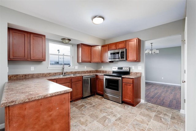 kitchen with sink, stainless steel appliances, decorative light fixtures, and a notable chandelier