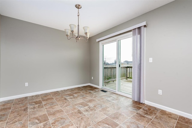 spare room with an inviting chandelier