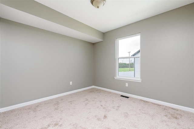 spare room with light colored carpet