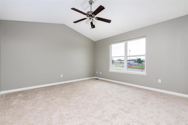 carpeted empty room with ceiling fan and lofted ceiling