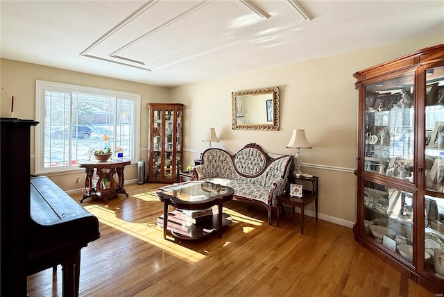 sitting room with hardwood / wood-style flooring