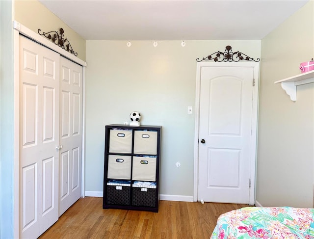 bedroom featuring a closet and light wood-type flooring