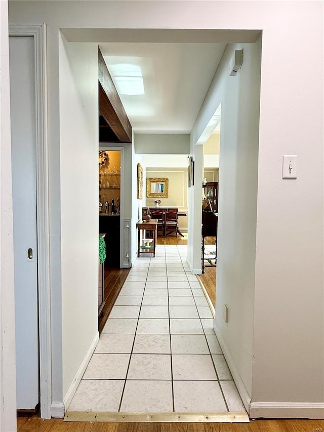 hallway featuring light tile patterned flooring