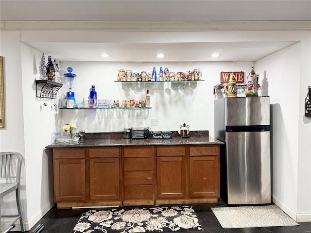 bar featuring stainless steel fridge and ornamental molding