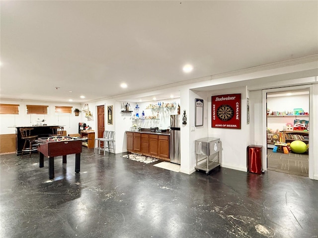 rec room featuring ornamental molding and bar