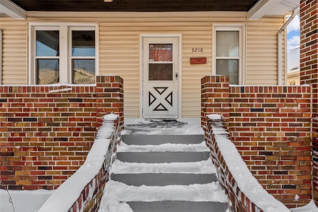 view of snow covered property entrance