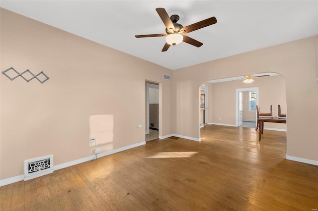 empty room with hardwood / wood-style floors and ceiling fan