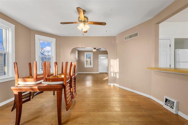 dining room with ceiling fan and light hardwood / wood-style flooring