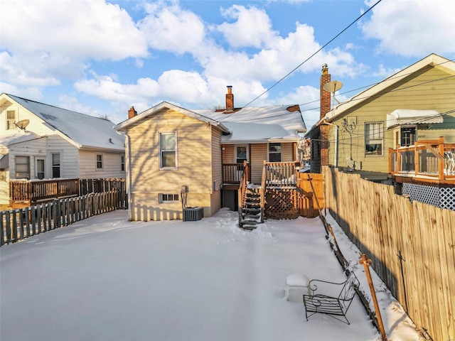 rear view of property with a wooden deck