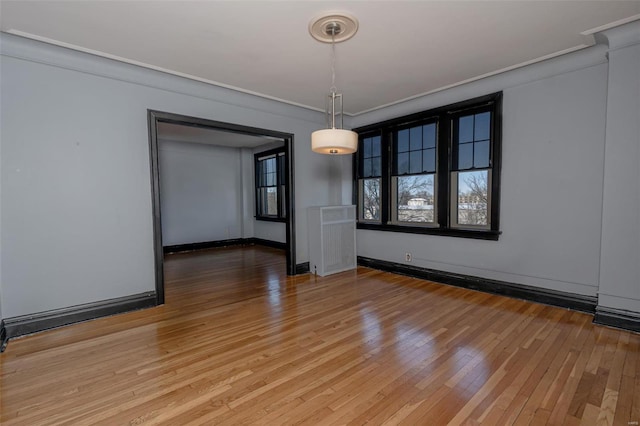 unfurnished dining area featuring crown molding and hardwood / wood-style flooring