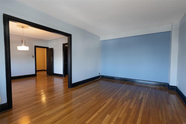 unfurnished room with dark hardwood / wood-style floors