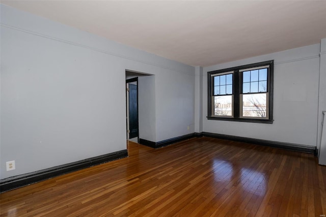 empty room with dark hardwood / wood-style floors