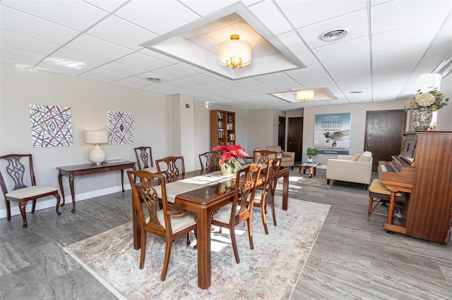 dining space featuring a paneled ceiling