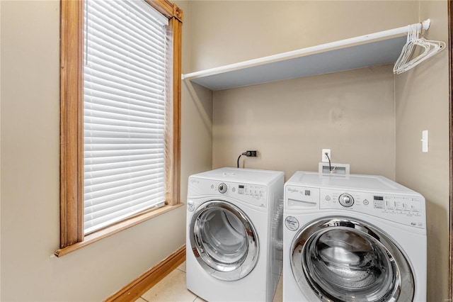 washroom featuring plenty of natural light, light tile patterned flooring, and separate washer and dryer