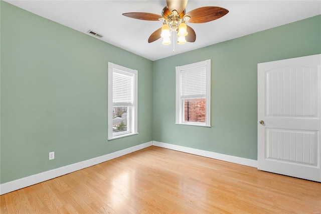 empty room with ceiling fan and light hardwood / wood-style floors