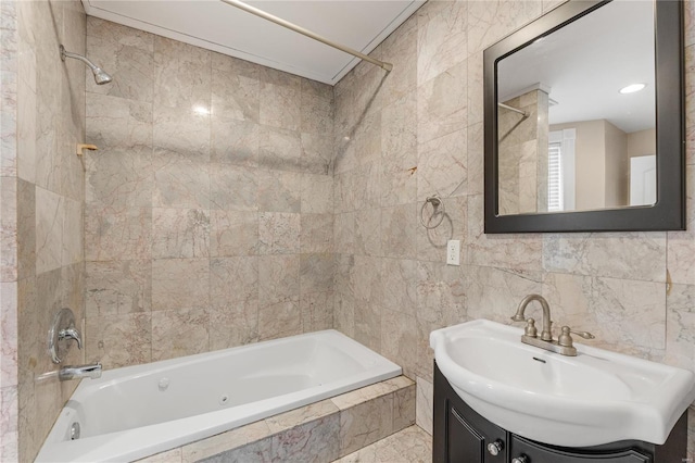 bathroom featuring tiled shower / bath combo, tile walls, and vanity