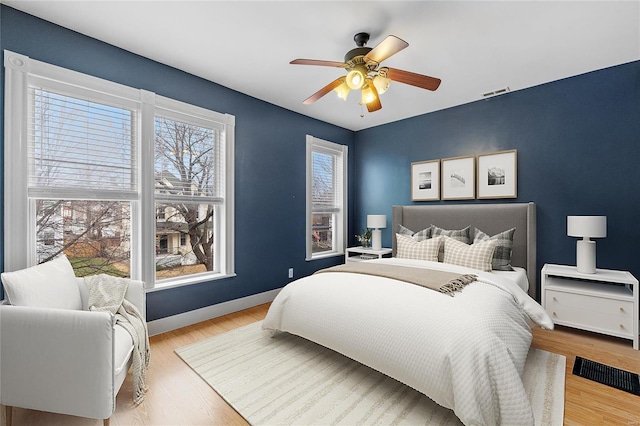 bedroom with light hardwood / wood-style flooring and ceiling fan