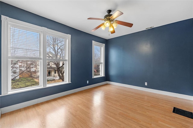 unfurnished room with ceiling fan and hardwood / wood-style flooring