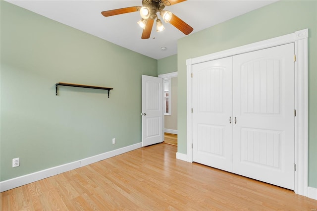 unfurnished bedroom featuring ceiling fan, a closet, and light hardwood / wood-style flooring