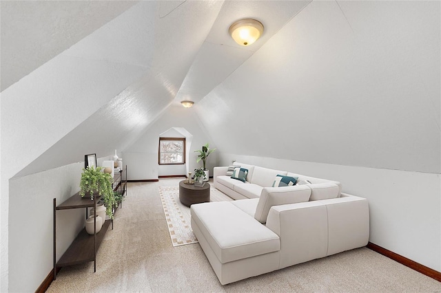 carpeted living room featuring vaulted ceiling