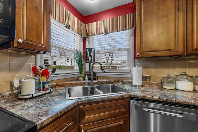 kitchen featuring backsplash, dishwasher, and sink