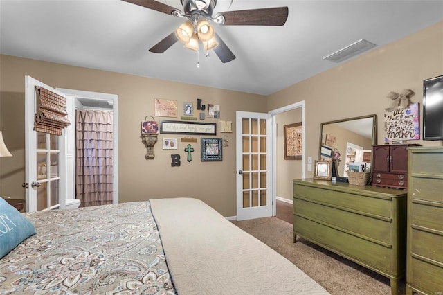 carpeted bedroom with french doors and ceiling fan