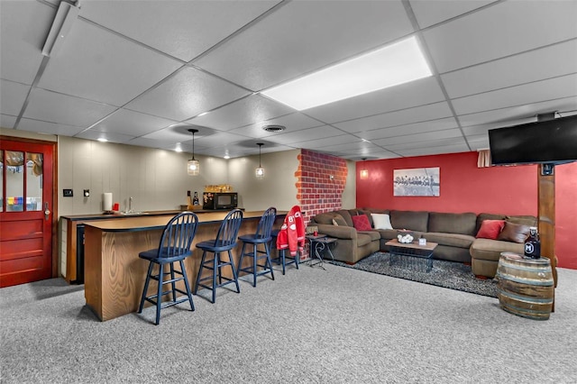 bar featuring a drop ceiling, carpet floors, and decorative light fixtures