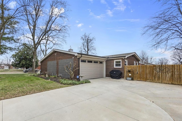 view of side of property featuring a lawn and a garage