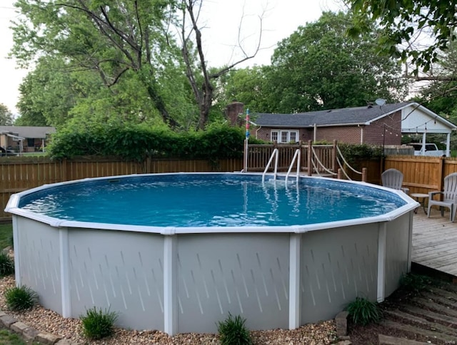 view of pool with a wooden deck