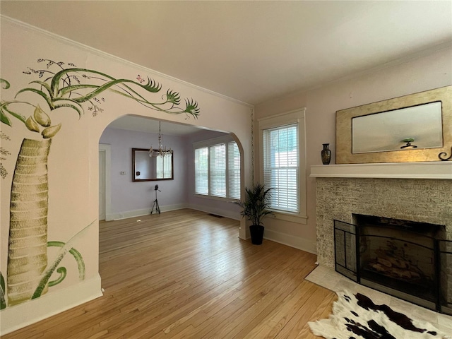 unfurnished living room with crown molding and hardwood / wood-style flooring