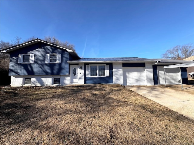 split level home featuring a front lawn and a garage