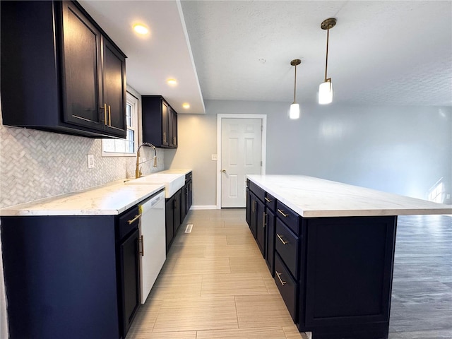 kitchen featuring a center island, sink, white dishwasher, decorative light fixtures, and decorative backsplash